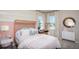 Charming bedroom with wicker headboard and striped bedding at 15037 Shady Palms Ln, Nokomis, FL 34275