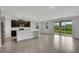 Open-concept kitchen with an island and sliding glass doors leading to the backyard at 12354 Nantahala Run, Parrish, FL 34219