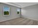 Well-lit bedroom with two windows and carpeted floors at 12354 Nantahala Run, Parrish, FL 34219