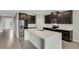 Modern kitchen boasting dark cabinetry, quartz countertops, and stainless steel appliances at 12354 Nantahala Run, Parrish, FL 34219