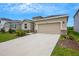 House exterior featuring a two-car garage and well-manicured landscaping at 12354 Nantahala Run, Parrish, FL 34219