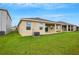 House exterior showcasing a backyard with green lawn at 12354 Nantahala Run, Parrish, FL 34219