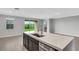 Kitchen island with sink and quartz countertop at 12354 Nantahala Run, Parrish, FL 34219