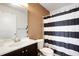 Clean bathroom with dark vanity and striped shower curtain at 3809 59Th W Ave, Bradenton, FL 34210