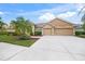 Single-story house with a three-car garage and landscaped front yard at 2995 Bravura Lake Dr, Sarasota, FL 34240