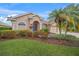 Single-story house with a two-car garage and landscaped front yard at 2995 Bravura Lake Dr, Sarasota, FL 34240