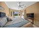 King sized bed in a bright bedroom with golf course views at 2995 Bravura Lake Dr, Sarasota, FL 34240