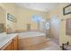 Bathroom with a large soaking tub and walk-in shower at 2995 Bravura Lake Dr, Sarasota, FL 34240