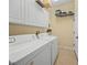 Laundry room with washer, dryer, and overhead storage at 2995 Bravura Lake Dr, Sarasota, FL 34240