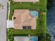Aerial view of a single-story house with a pool and solar panels on the roof at 2995 Bravura Lake Dr, Sarasota, FL 34240