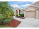 Single-story house with a two-car garage and landscaped front yard at 2995 Bravura Lake Dr, Sarasota, FL 34240