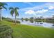 Serene lakefront view with lush landscaping at 2995 Bravura Lake Dr, Sarasota, FL 34240