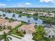 Single-Gathering house with a two-car garage and a lush lawn at 2995 Bravura Lake Dr, Sarasota, FL 34240