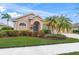 Single-story house with a two-car garage and landscaped front yard at 2995 Bravura Lake Dr, Sarasota, FL 34240