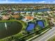 Community overview: tennis courts, pool, lake at 2995 Bravura Lake Dr, Sarasota, FL 34240