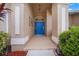 Inviting entryway with a bright blue door and a light tan stucco exterior at 2995 Bravura Lake Dr, Sarasota, FL 34240