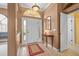 Bright and spacious foyer with tile floors and a coat rack at 2995 Bravura Lake Dr, Sarasota, FL 34240