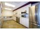 Community kitchen with stainless steel appliances and light colored cabinets at 1026 Bird Bay Way # 276, Venice, FL 34285