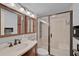 Bathroom with walk-in shower, modern fixtures, and a wooden vanity at 1026 Bird Bay Way # 276, Venice, FL 34285