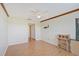 Spacious bedroom with wood floors, ceiling fan and access to hallway at 1026 Bird Bay Way # 276, Venice, FL 34285