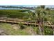Scenic exterior view of a wooden walkway through a mangrove forest, with waterfront access at 1026 Bird Bay Way # 276, Venice, FL 34285