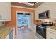 Well-equipped kitchen boasting stainless steel appliances, granite countertops, and beautiful wall design at 1026 Bird Bay Way # 276, Venice, FL 34285