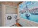 Convenient laundry room with washer, dryer, and small table at 1026 Bird Bay Way # 276, Venice, FL 34285