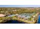 Community overview with pools, tennis courts, and a lake at 5679 Ferrara Dr, Sarasota, FL 34238