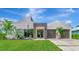 Contemporary home featuring unique architectural design, stone accents, lush landscaping, and an attached two-car garage at 8175 Dittmar St, Port Charlotte, FL 33981