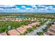 Aerial view of a home with a neighborhood and lake in the background at 9019 Heritage Sound Dr, Bradenton, FL 34212