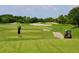 Golfer teeing off on a beautiful course at 9019 Heritage Sound Dr, Bradenton, FL 34212