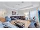 Living room with hardwood floors, sectional sofa, and large TV at 9019 Heritage Sound Dr, Bradenton, FL 34212