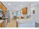 Well-equipped kitchen featuring stainless steel appliances and light wood cabinets at 9019 Heritage Sound Dr, Bradenton, FL 34212