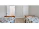 Two twin beds in a well-lit bedroom with an adjacent door at 9019 Heritage Sound Dr, Bradenton, FL 34212