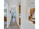 Bright hallway with wood-look floors, leading to living room and kitchen at 9019 Heritage Sound Dr, Bradenton, FL 34212