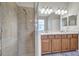 Double vanity, large shower, and updated light fixtures in this bathroom at 9019 Heritage Sound Dr, Bradenton, FL 34212