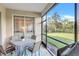 Screened patio features dining furniture and views of the backyard at 9019 Heritage Sound Dr, Bradenton, FL 34212
