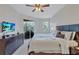 Main bedroom with king-size bed, TV, and sliding door to patio at 9019 Heritage Sound Dr, Bradenton, FL 34212