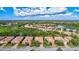 Aerial view of a single-Gathering home in a residential community with a lake at 9019 Heritage Sound Dr, Bradenton, FL 34212