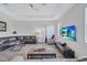 Open living room with hardwood floors, comfortable seating, and large TV at 9019 Heritage Sound Dr, Bradenton, FL 34212
