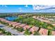 Aerial view of a home in a community with lake and lush landscaping at 9019 Heritage Sound Dr, Bradenton, FL 34212
