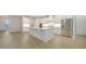 Modern kitchen featuring white cabinets, quartz countertops, and stainless steel appliances at 12420 Destin Loop, Venice, FL 34293