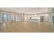 Open concept kitchen and living area with white cabinets at 12420 Destin Loop, Venice, FL 34293