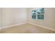 Light-filled bedroom with wood-look flooring and a large window at 12420 Destin Loop, Venice, FL 34293