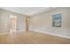 Well-lit bedroom with hardwood floors and access to bathroom at 12420 Destin Loop, Venice, FL 34293