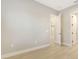 Spacious bedroom with wood-look floors and access to other rooms at 12420 Destin Loop, Venice, FL 34293