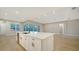 Modern kitchen with a large island, white cabinets, and stainless steel appliances at 12420 Destin Loop, Venice, FL 34293