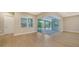 Gathering room with sliding glass doors leading to pool area at 12420 Destin Loop, Venice, FL 34293