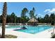 Community lap pool with a thatched roof cabana and plenty of space for relaxing at 12420 Destin Loop, Venice, FL 34293