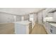 Spacious kitchen with large island, stainless steel appliances, and white shaker cabinets at 12420 Destin Loop, Venice, FL 34293